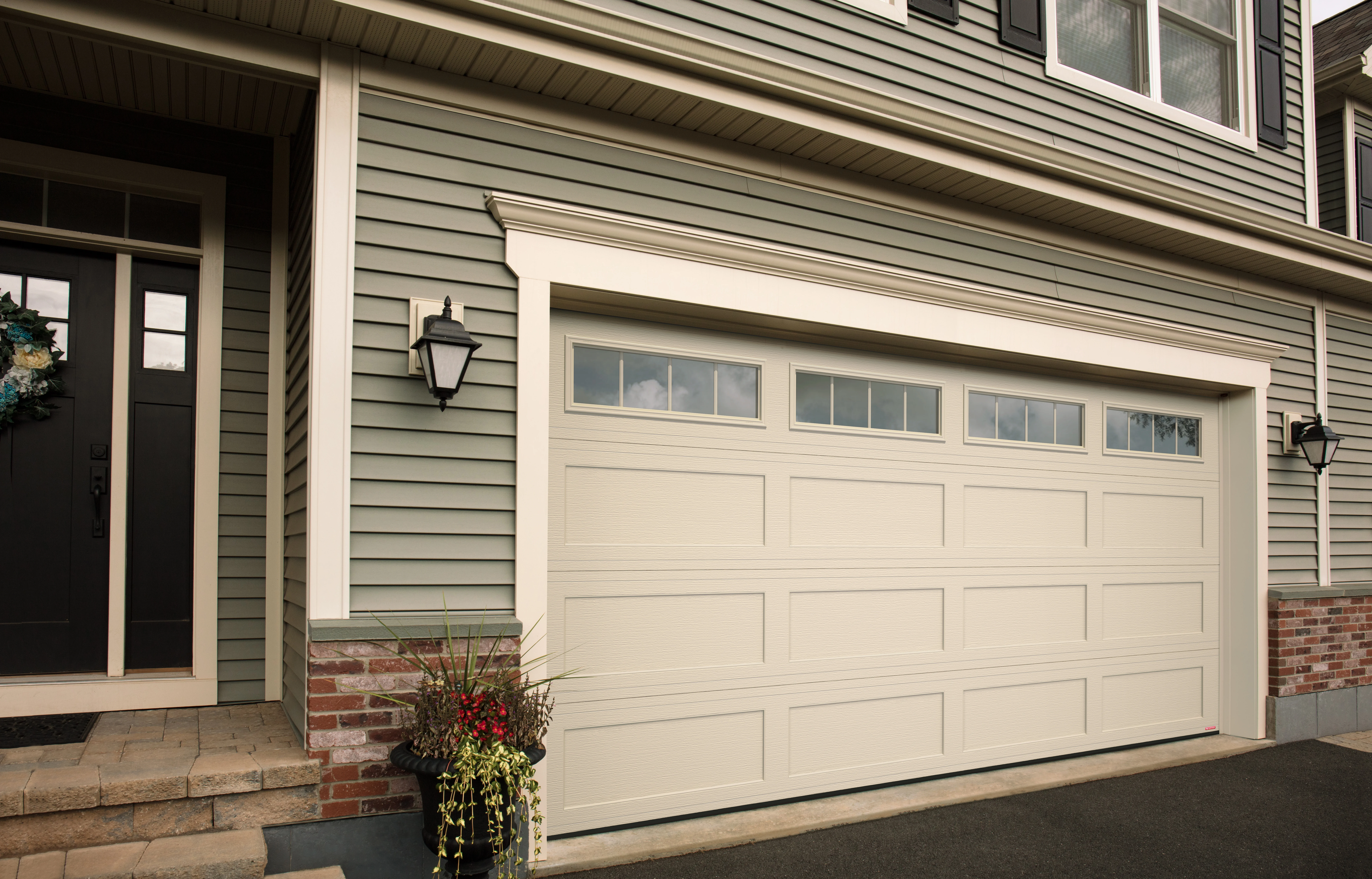 Traditional raised panel garage door with windows — Metro Vancouver