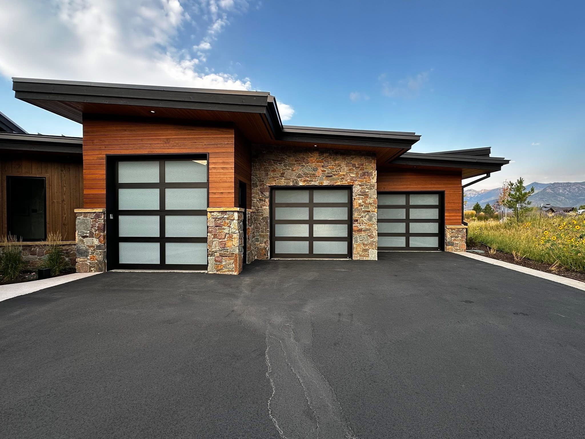 Full-view aluminum and frosted glass garage door on contemporary West Coast home