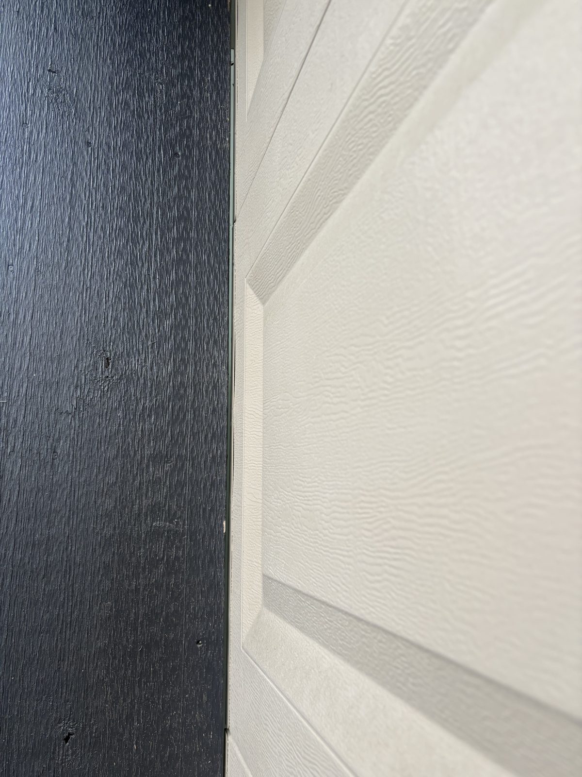 Garage door side frame without weather strip showing gap — before installation